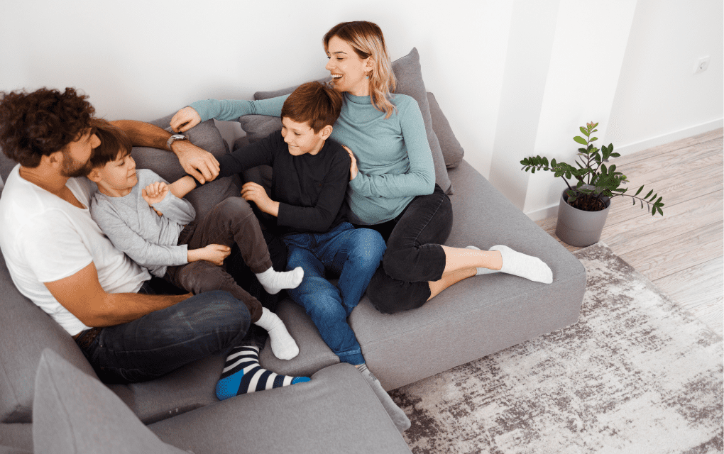 Family sitting on couch talking about how to improve family communication.