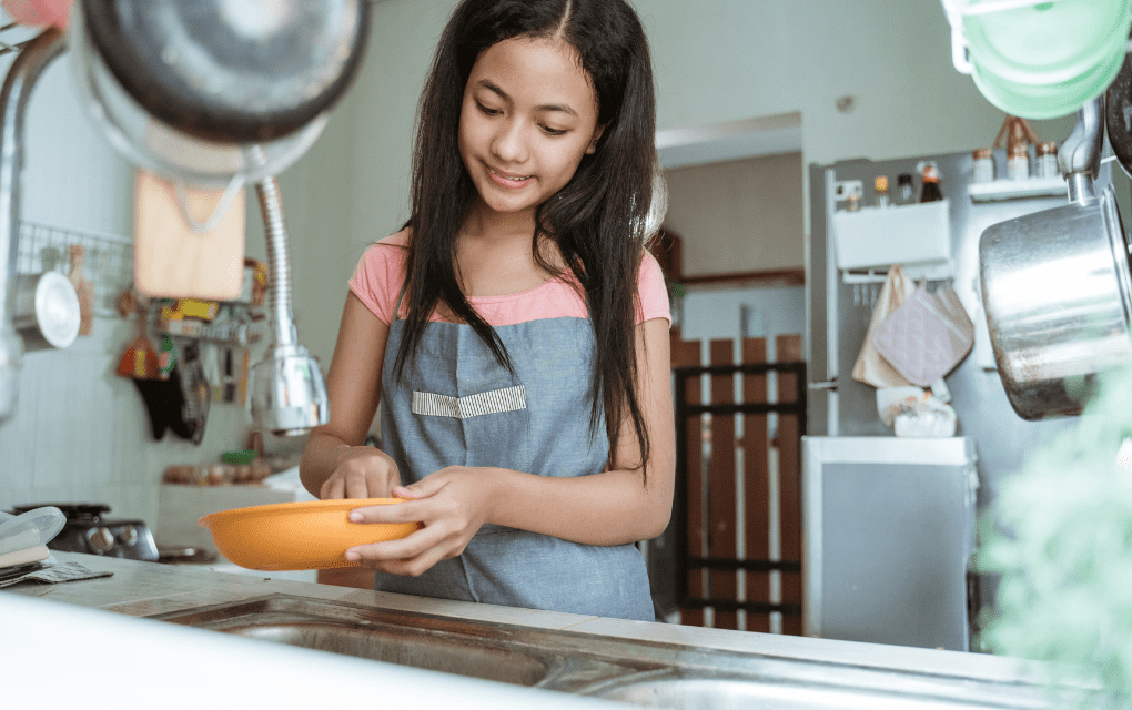 A teenager helps around the house helping her work ethic